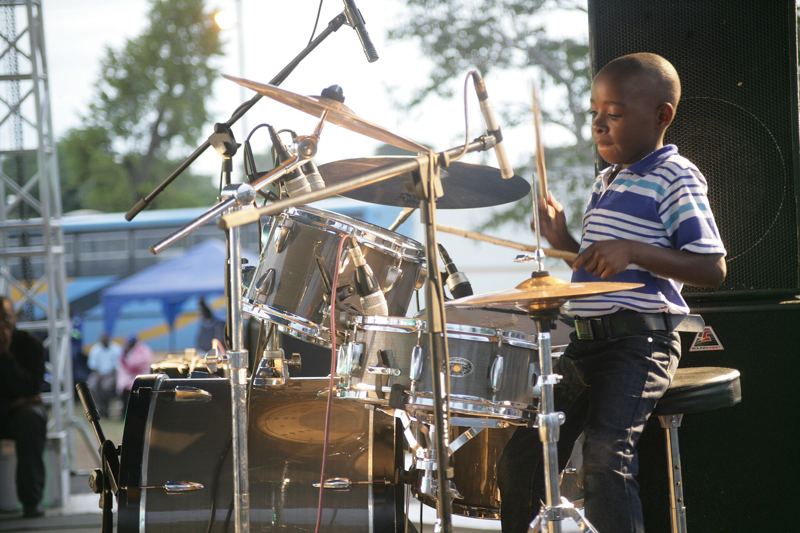 A young drummer playing a drum kit