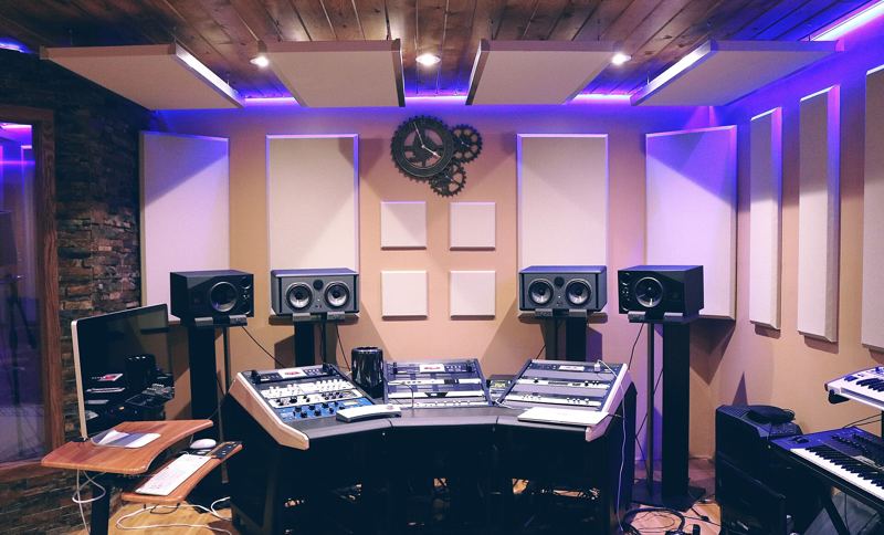 A recording studio control room with mixing desk and monitors
